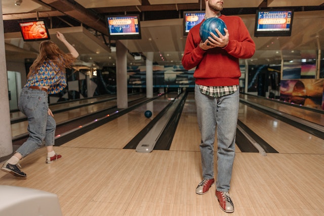 Bowling: This involves players rolling a ball down a lane to knock over pins.