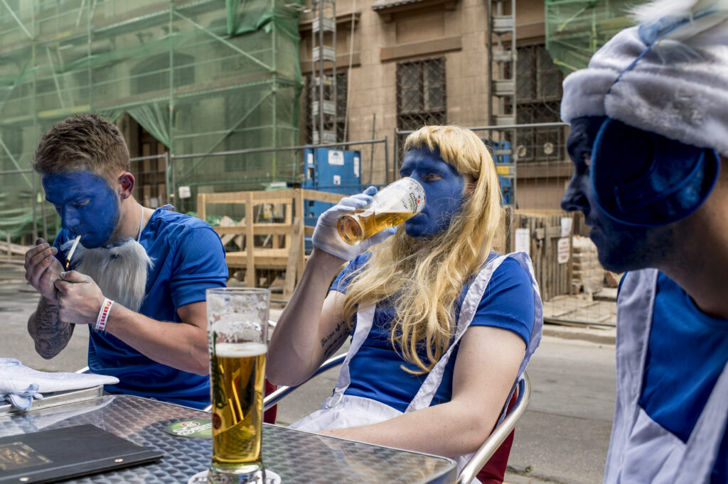 Smurfs drinkin' beer on Budapest's streets during a bachelor party.