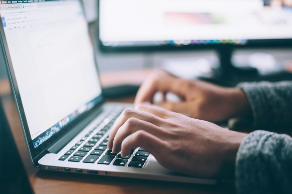 Research and Gathering Material: a person typing on a laptop